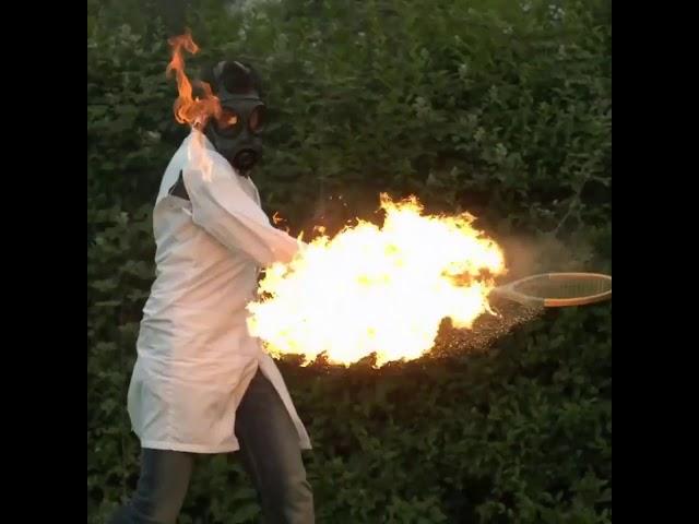 Man hits fiery tennis ball in slow motion