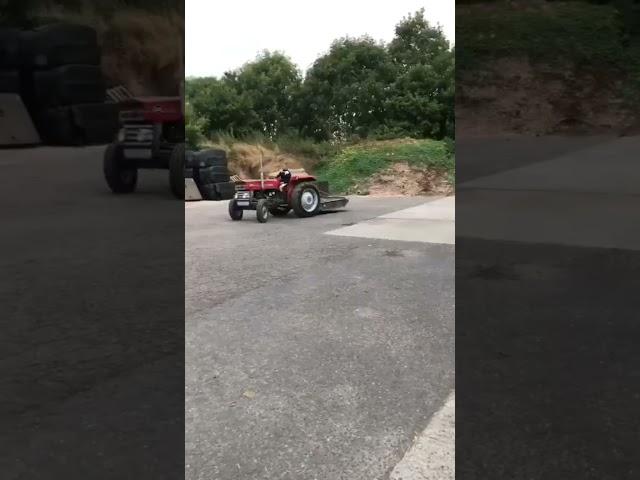 Scott driving the massy 135 with the mower on the back