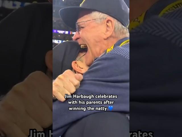 The Harbaughs embrace after Michigan wins the national championship 