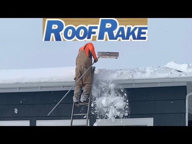 Clearing Snow From Roof With A Roof Rake