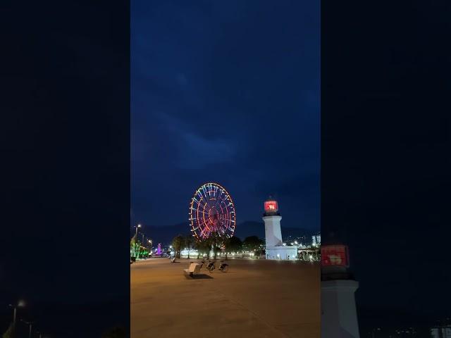 Ferris Wheel with light house #light #fun #georgia #winter #travel #batumi #fyp