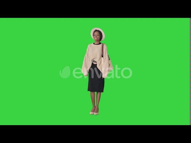 Fashionable African American Woman Posing in Knitwear and White Hat on a Green Screen, Chroma Key