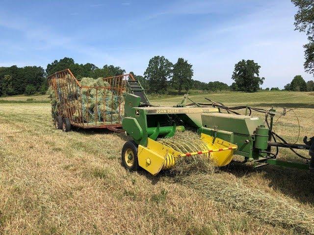 JOHN DEERE square Baler 339 baling hay in Sweden with New Holland TL90A tractor