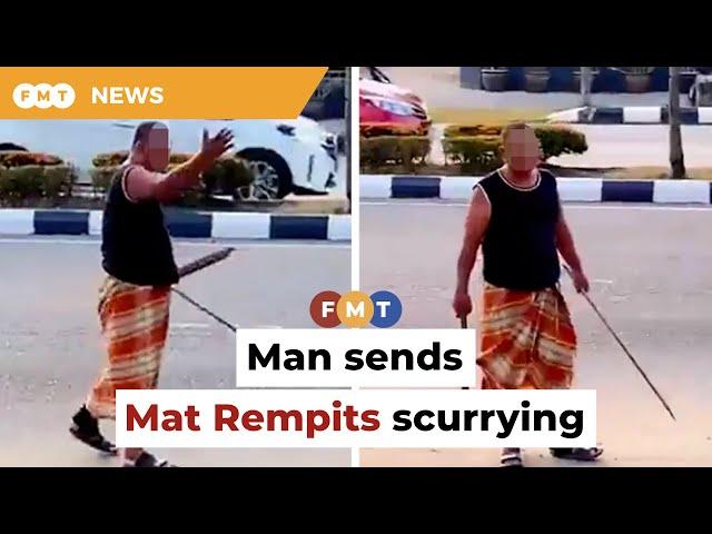 Man brandishing sticks drives away noisy Mat Rempits