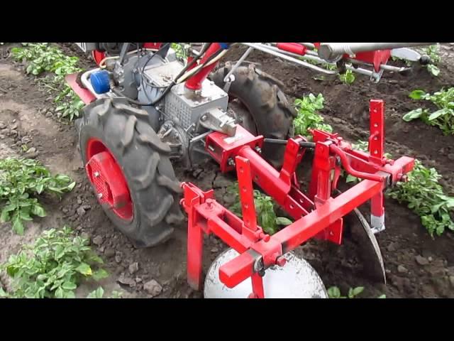 First hilling potatoes after planting tractor.