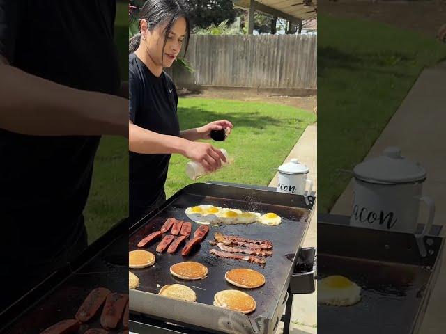 Woman is cooking breakfast for her family on the Blackstone grill!