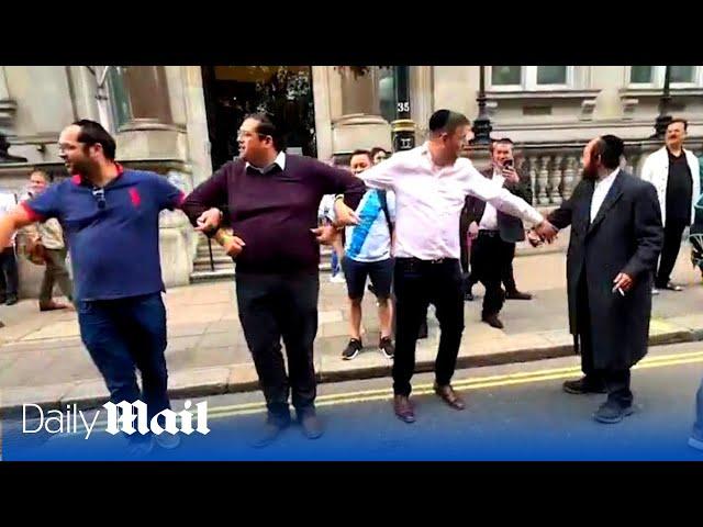 Moment public form human chain to push Just Stop Oil protesters out of the road