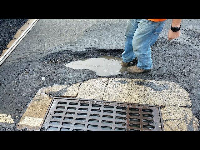 Oblivious Drivers Hit Massive Pothole