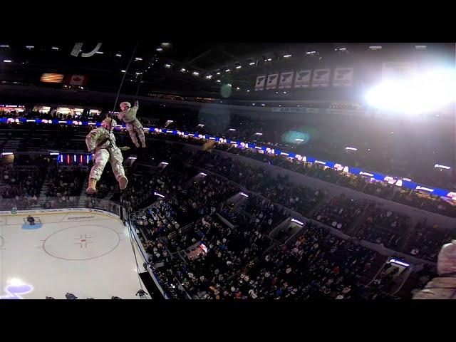 POV: Military member rappels from area rafters to deliver game puck