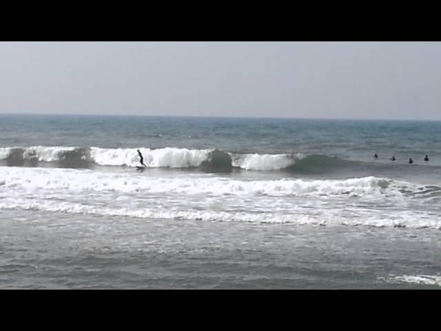 Wave surfers at Tel Aviv Hilton beach