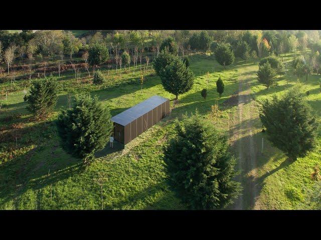 MIMA Light is a small prefabricated house raised up from the landscape on a near-invisible base