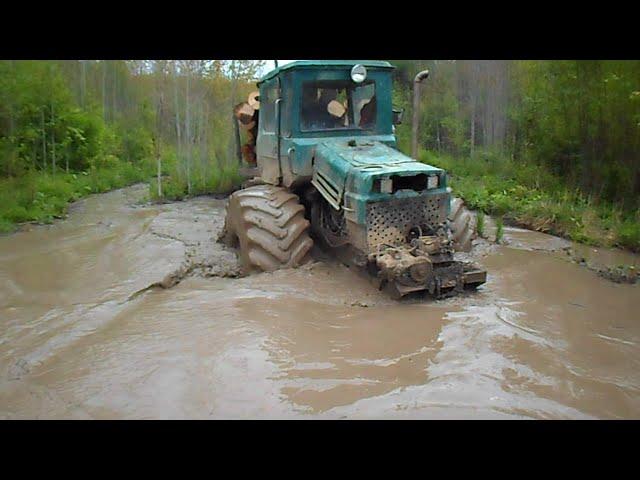 Homemade forwarder logging in wet forest, deep water