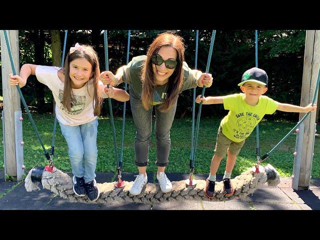 Lika and Andrew play on the kids playground with mommy