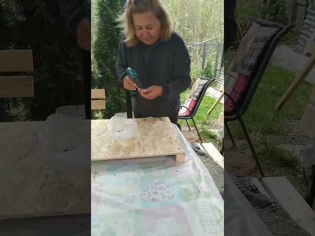 Woman building a nest for chickens