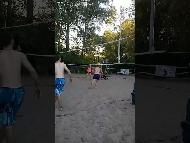 Beach volleyball, the player hit the ball successfully through the center.