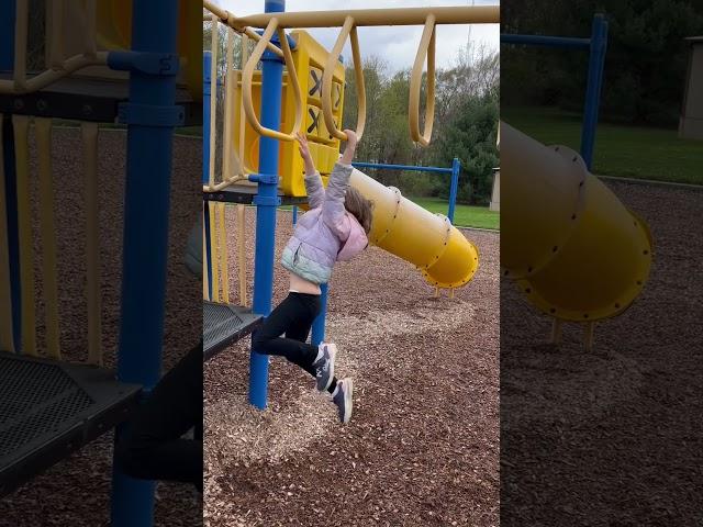 Alexandra doing the monkey bars