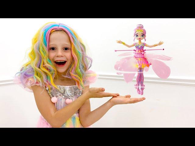 Nastya is dancing with a new flying doll at home