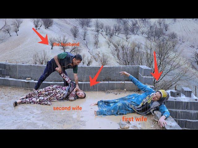 The second wife attacks the first wife in heavy rain and the husband throws the second wife out.