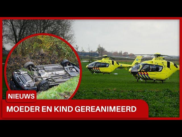 Vrouw met twee kinderen met auto in sloot in Uitwijk: Twee personen gereanimeerd