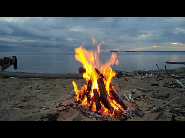 Swimming and bonfire at the nude beach with fable wood constructions, great clouds and still