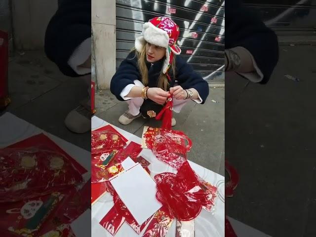 Italian girl whowas selling Chinese New Year goods ata stall on the street.Her hat is so authentic!