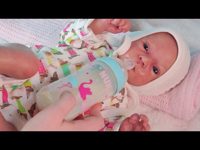 Reborn baby doll feeding and changing clothes and diapers