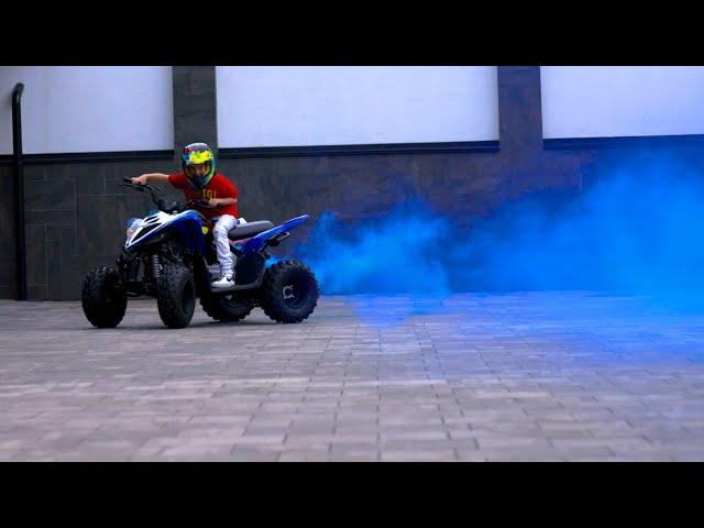 Boy Riding An ATV With Blue Smoke