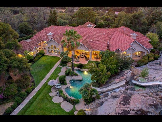 Private 10-acre estate with over 10,000 sq ft of single level living with resort style backyard!