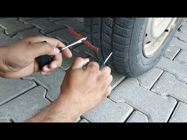 Automobile Tire Repairing Fitting a Rubber Tire Repairing a Motorcycle Tire with a wick - Repair