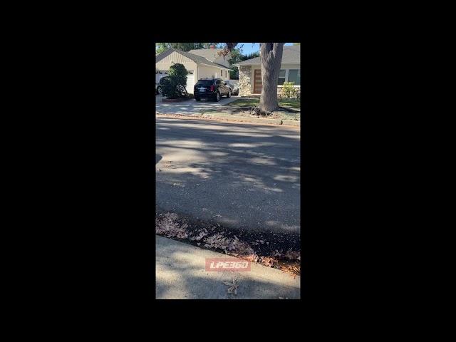 Runaway vacuum robot in street