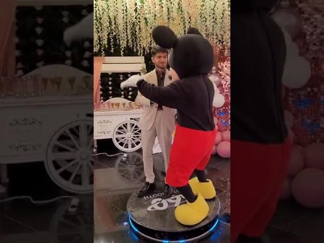 Freedom From Desire; Mickey Mouse Dancing on booth with a friend