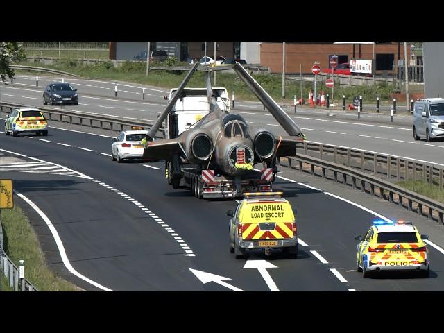 Police escort military aircraft as traffic stops for wide load; Blackburn Buccaneer attack plane