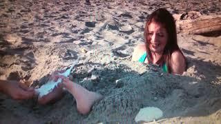 Tickled in the sand!! Amazing feet tickling. She is so ticklish