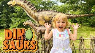 Margo and family play with dinosaurs in the park