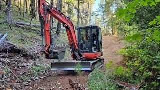 Clearing a access road with the Kubota KX 040 4