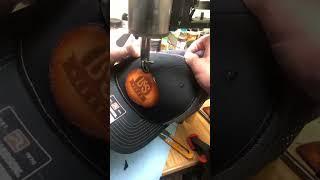 Using my Amazon special Chinese shoe patcher to sew a custom laser engraved hat patch.