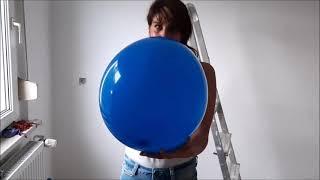 Looner girl blow to pop a blue balloon