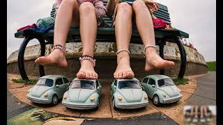 Barefoot girls playing with old car