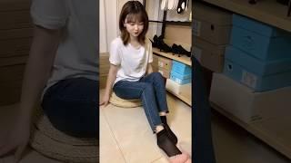 Shy girl's black nylon feet