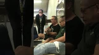 Foreign passenger Play his guitar while waiting for his flight