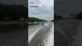 Viral video shows surfboarder's wild ride on flooded Arkansas interstate