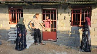 A step forward in building the Ali family's house: installing doors and windows