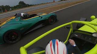 Caterham 620r with Lotus 311 going through traffic at Oulton Park