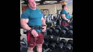 Giant muscle bull with broad back and big glutes pumping iron