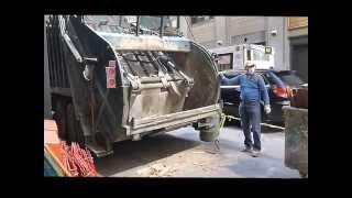 New York City garbage trucks - Day and night time curbside trash and waste pick-ups in mid Manhattan