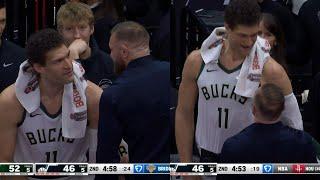 Conor McGregor sizing up Brook Lopez on the Bucks bench 