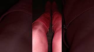 Crossdresser-transvestite. Red stockings, skirt and high-heeled boots.