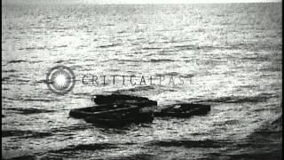 Survivors of USS Indianapolis floating in rubber rafts at sea and being rescued b...HD Stock Footage