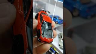 Model of a Toyota GR86 LB Nation in red. This model car is part of the Mini GT series
