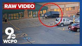 RAW VIDEO: Woman runs over innocent bystander at grocery store after striking intended target